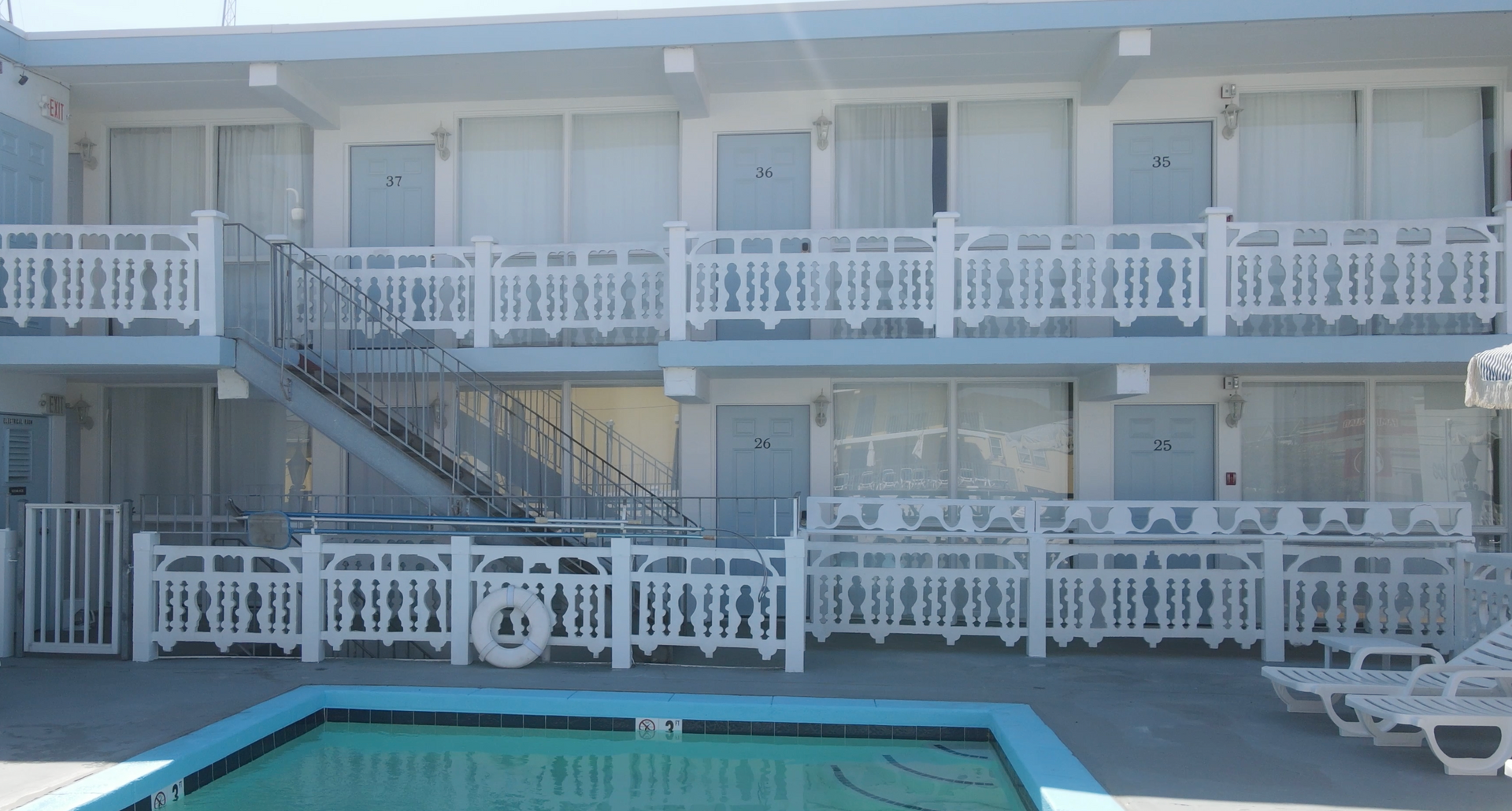 A large building with a swimming pool in front of it