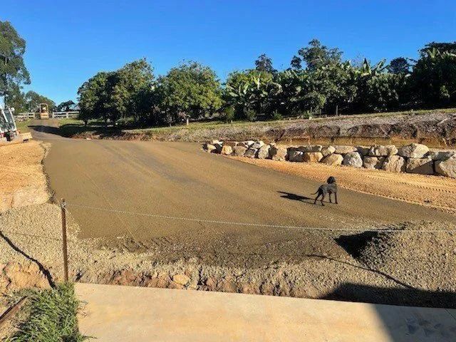 Dirt Road Under Construction With a Dog Standing on It — Blue Dog Earthmoving Landscape Supplies in Newee Creek, NSW