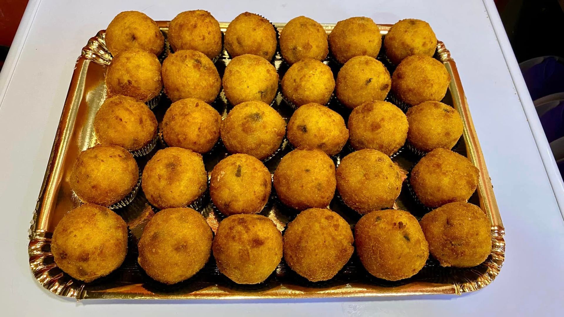 Un vassoio di palline di cibo fritto su un tavolo.