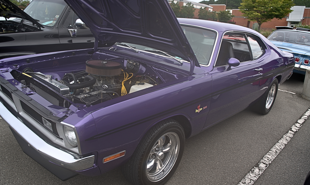 purple muscle car with raised hood