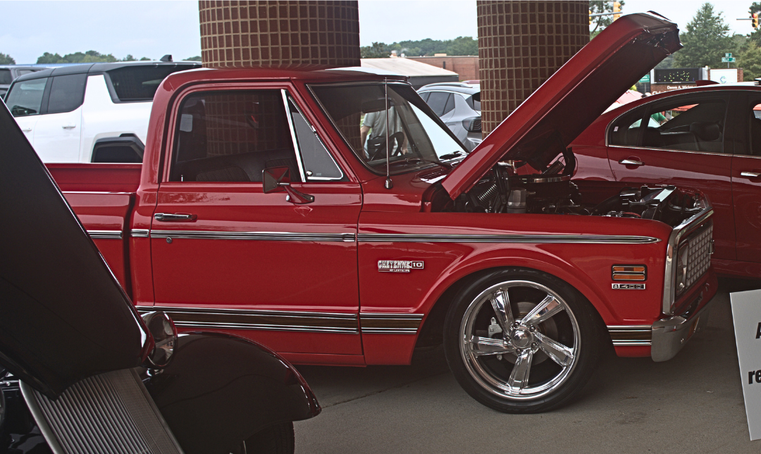 red truck with raised hood