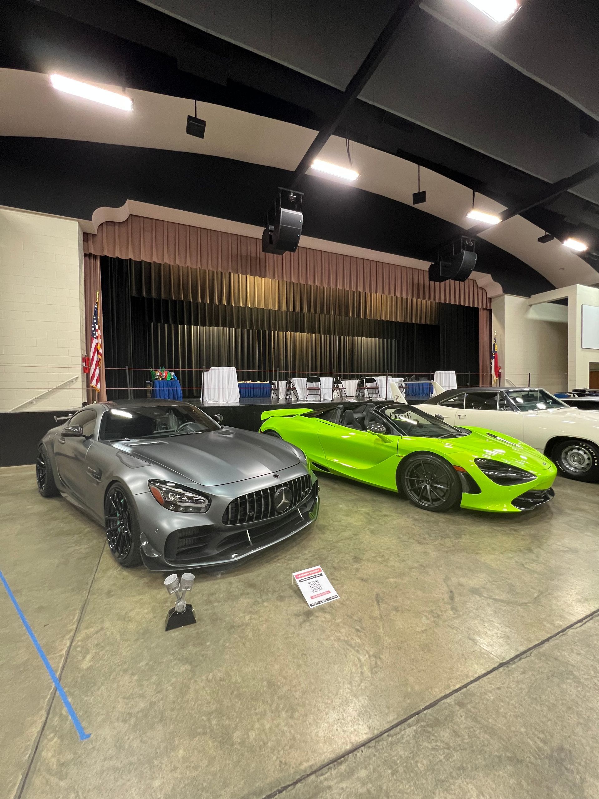 Sleek gray Mercedes roadster and lime green sports car