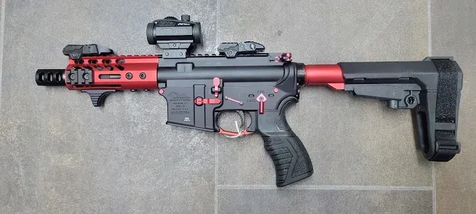 A photo of black and red gun