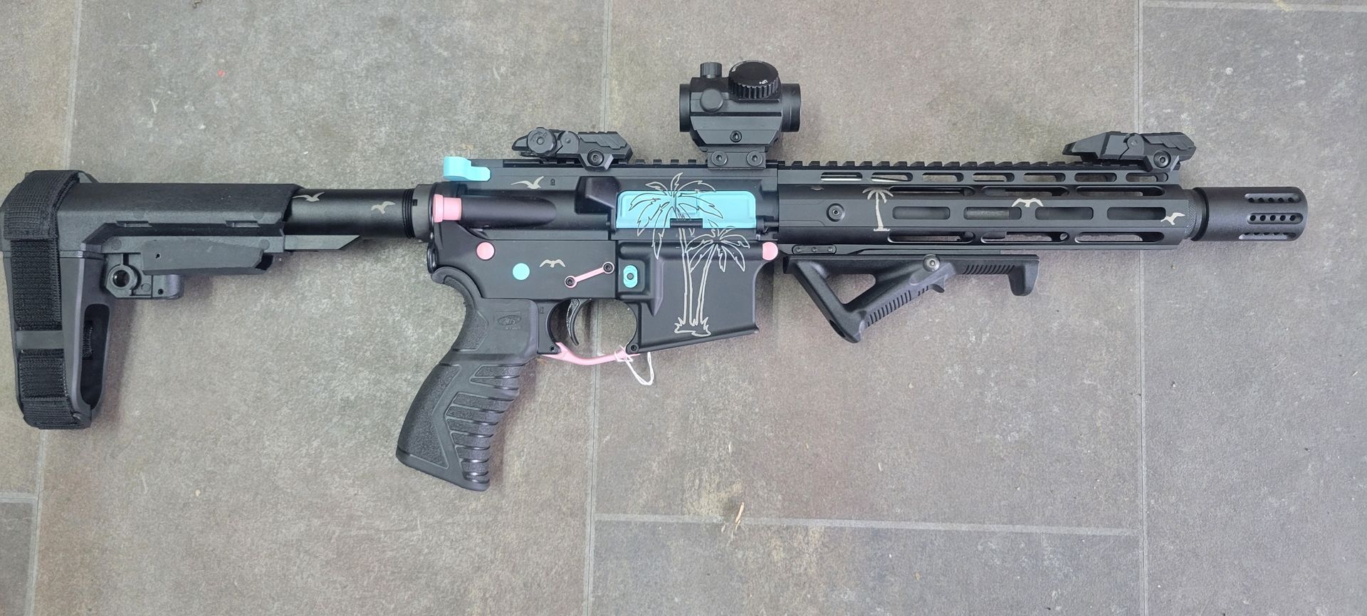 A photo of gun with a palm trees on it