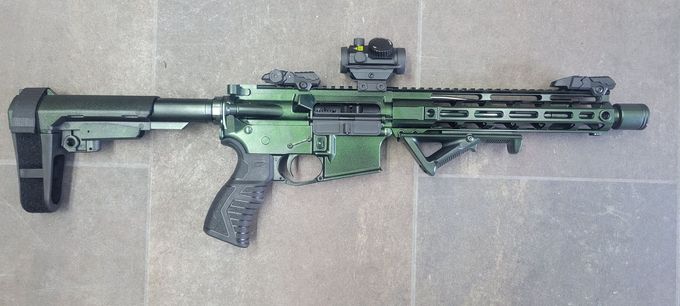 A photo of black and green gun