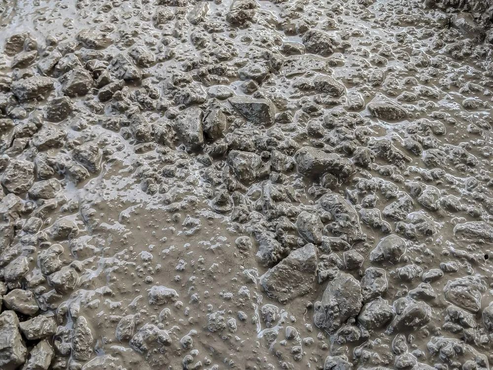 Wet, Freshly Poured Concrete Mix, With Gray Stones — Northern Rivers Concrete Construction in Pimlico, NSW