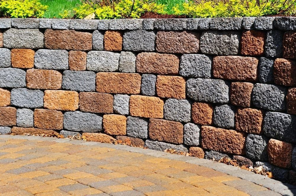 Stone Retaining Wall With Orange, Gray — Northern Rivers Concrete Construction in Pimlico, NSW