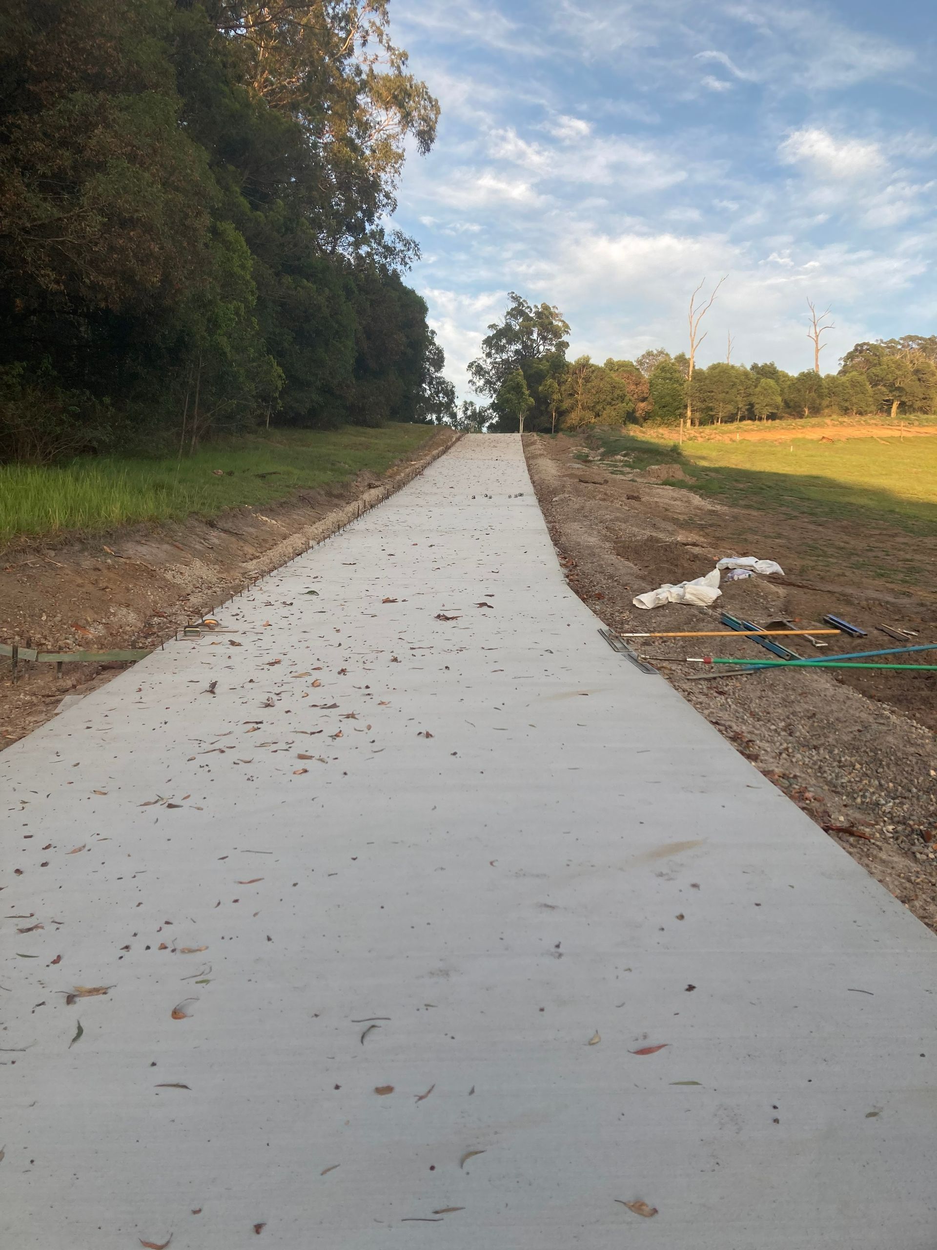 Light Gray Concrete Path Slopes Uphill — Northern Rivers Concrete Construction in Pimlico, NSW