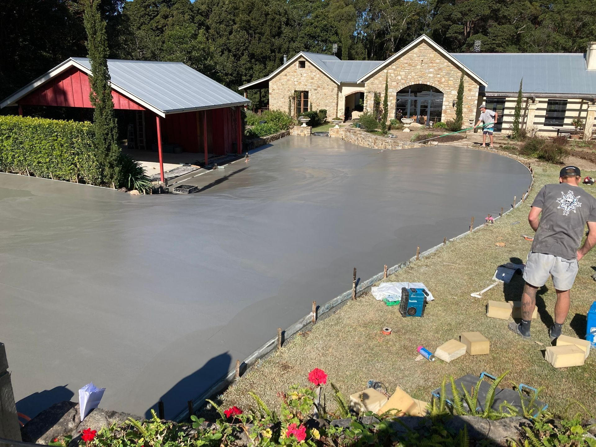 New Concrete Driveway Being Poured Next to a House — Northern Rivers Concrete Construction in Pimlico, NSW
