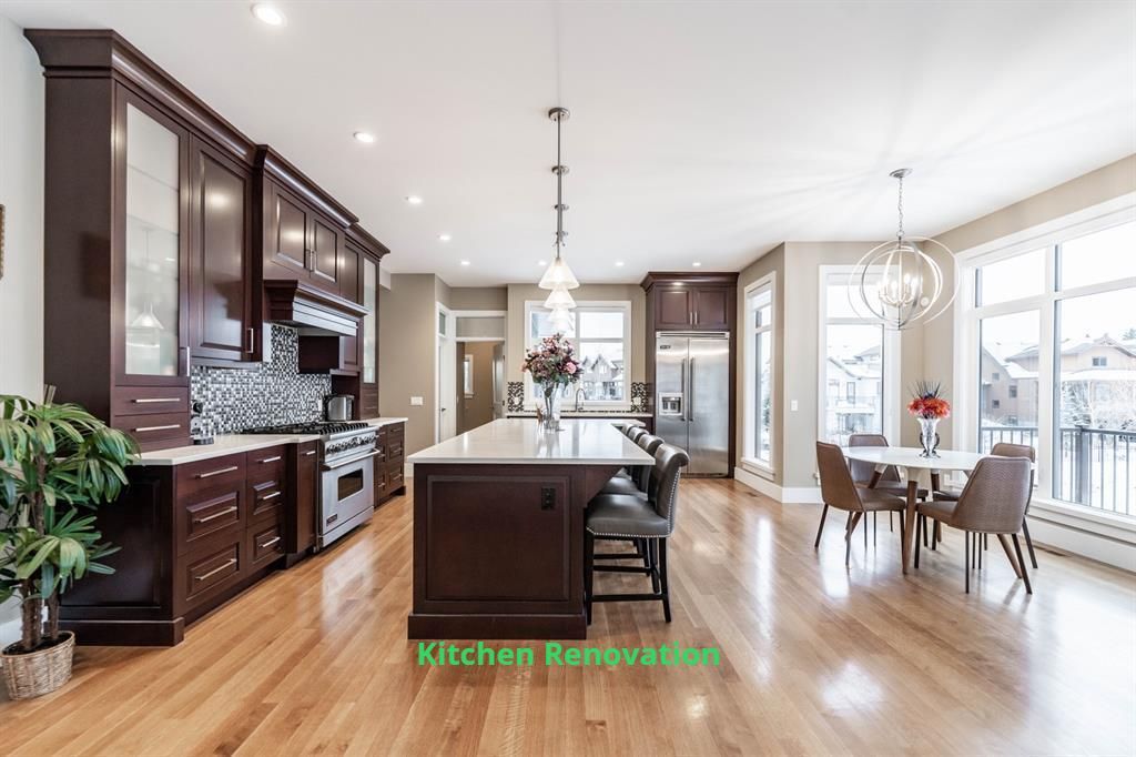 A kitchen and dining room in a house with hardwood floors