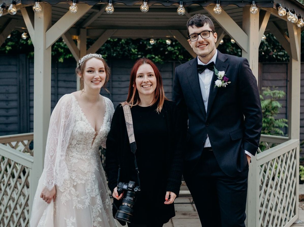 photographer with wedding couple
