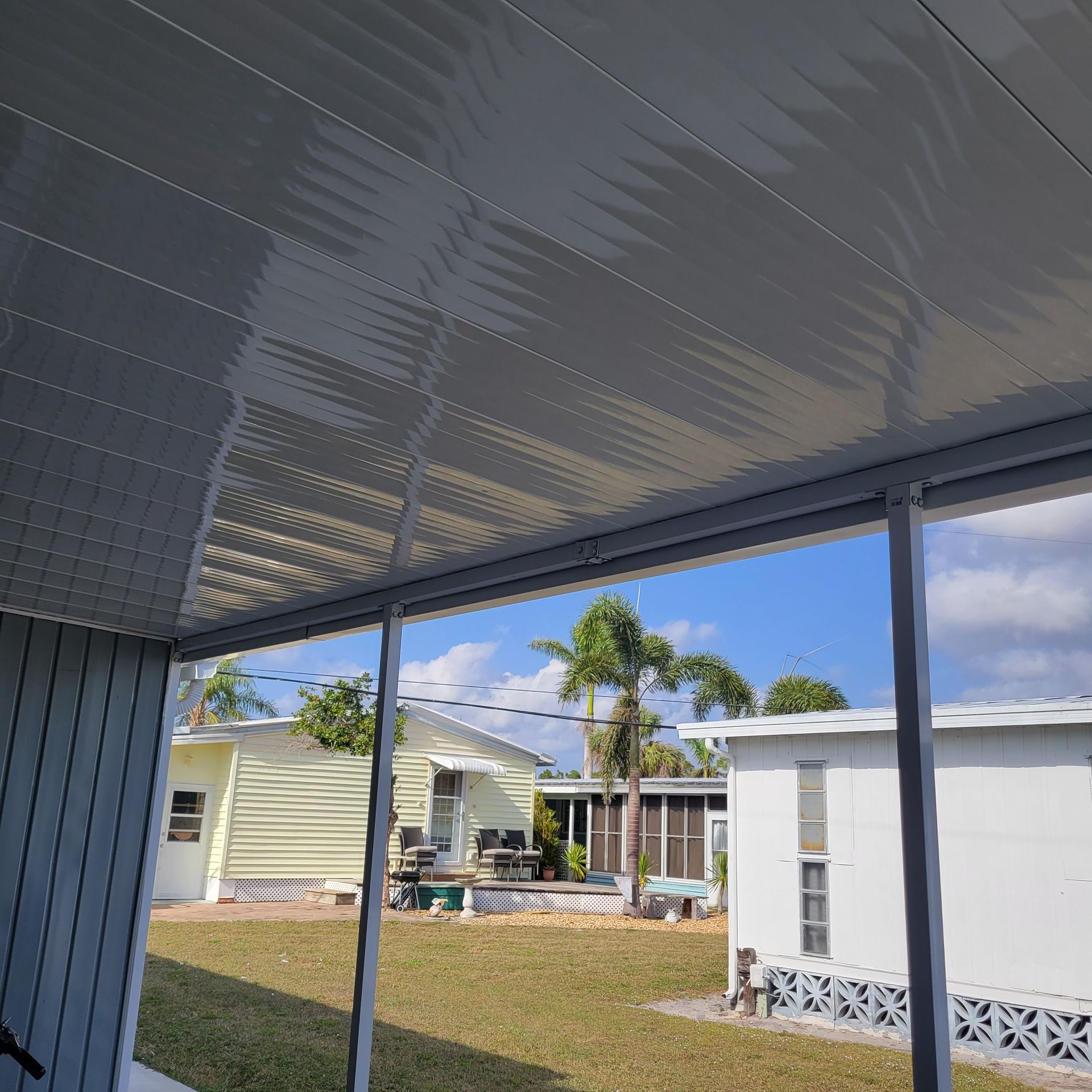A view of a mobile home park from a screened in porch.