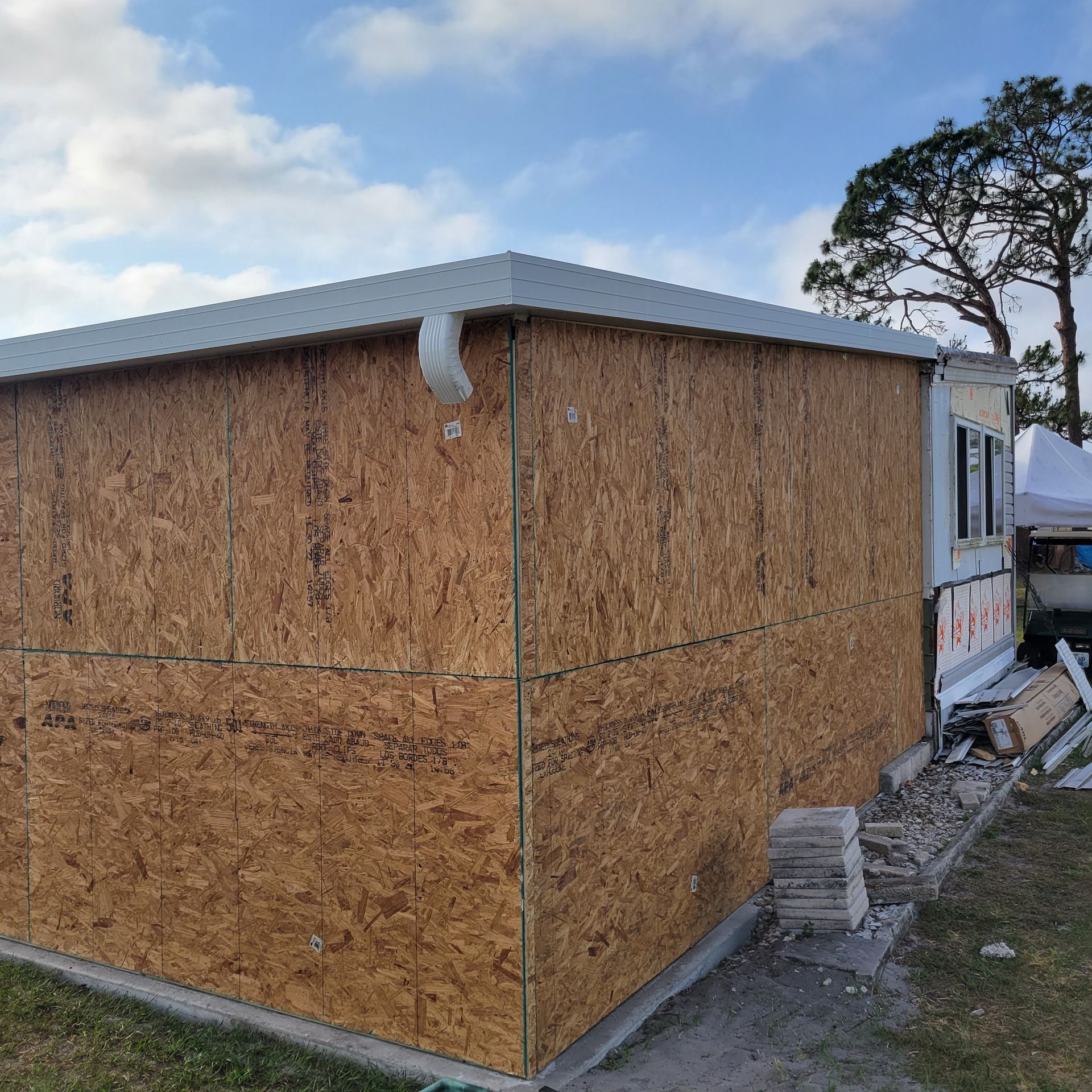 A house with a lot of plywood on the side of it