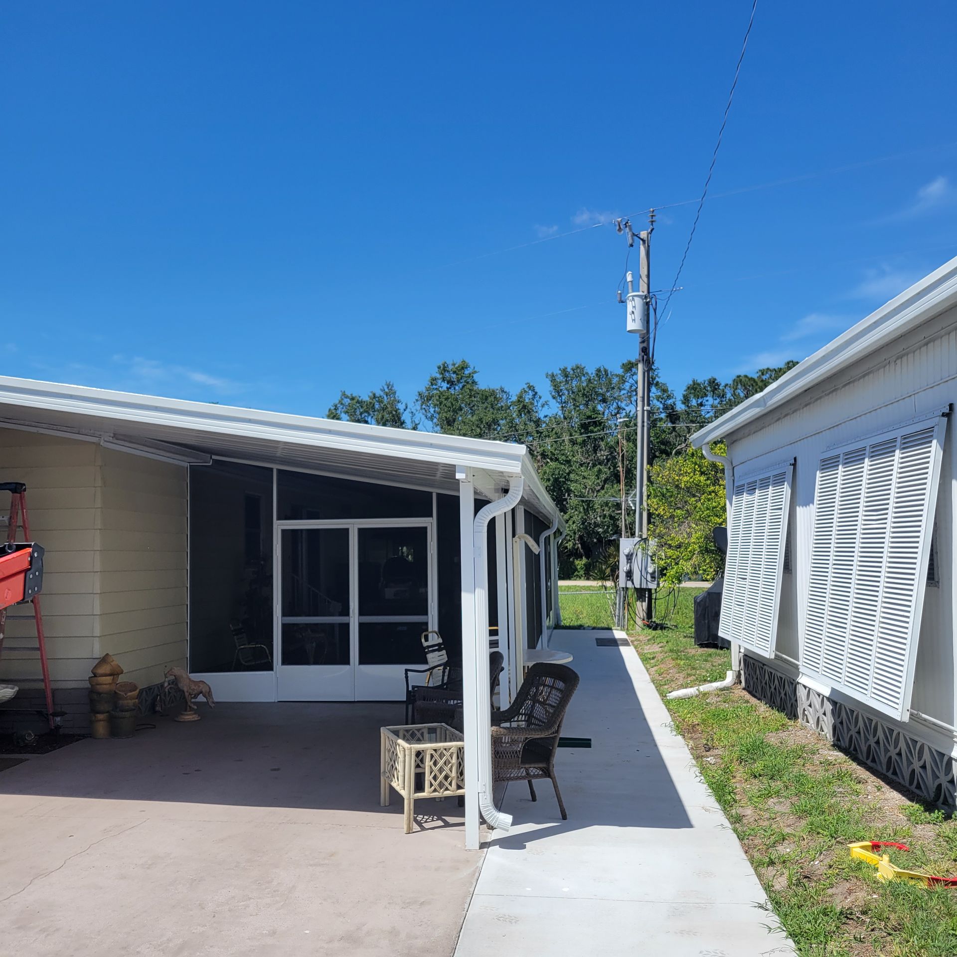 A house with a porch and a ladder in front of it