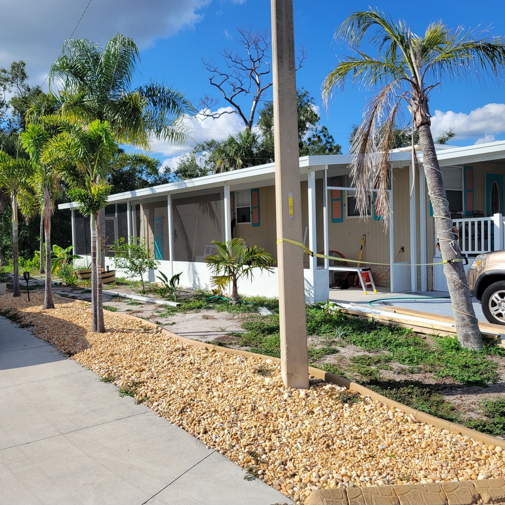 A mobile home with a car parked in front of it