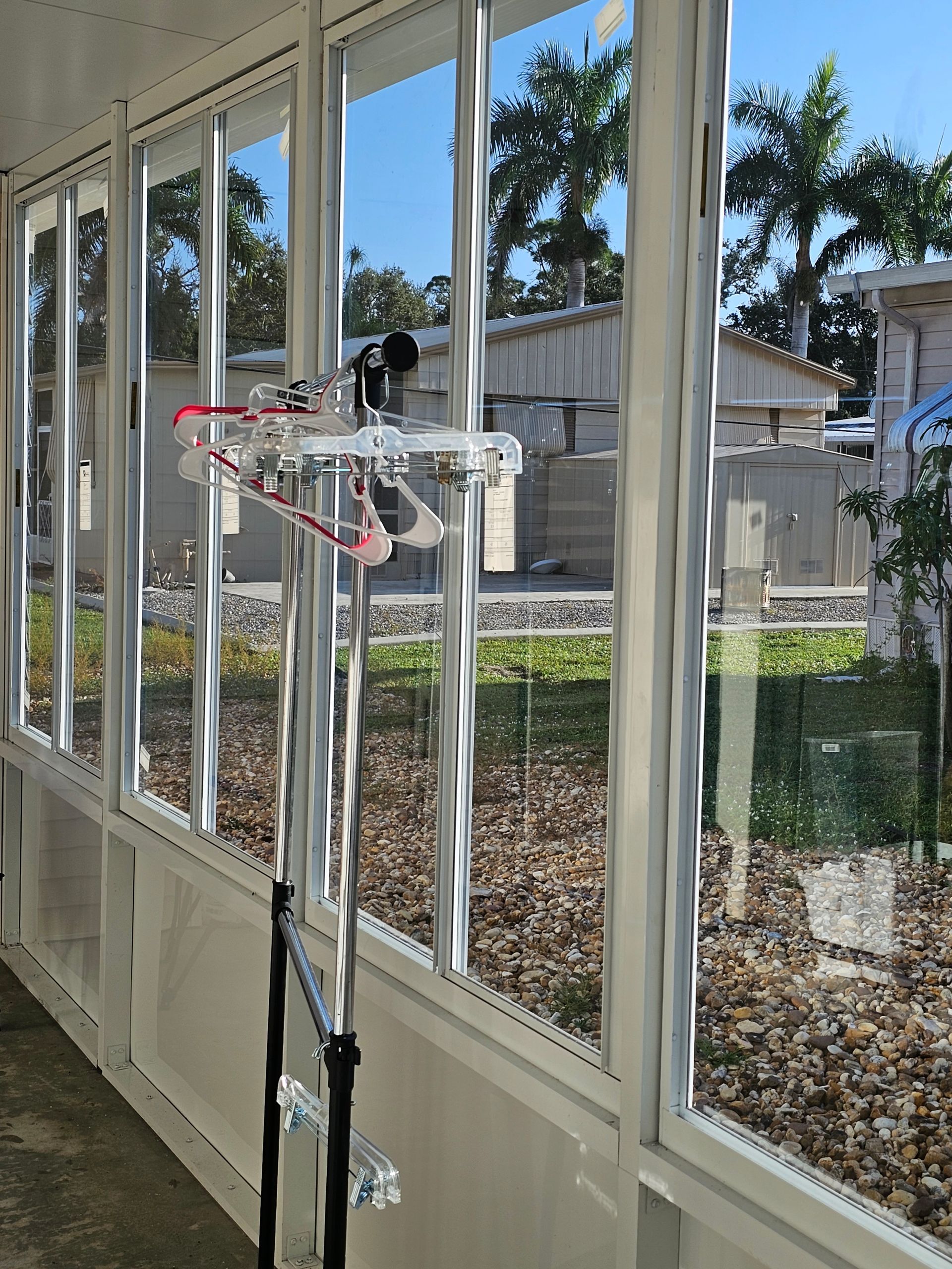 A room with a lot of windows and a reflection of trees
