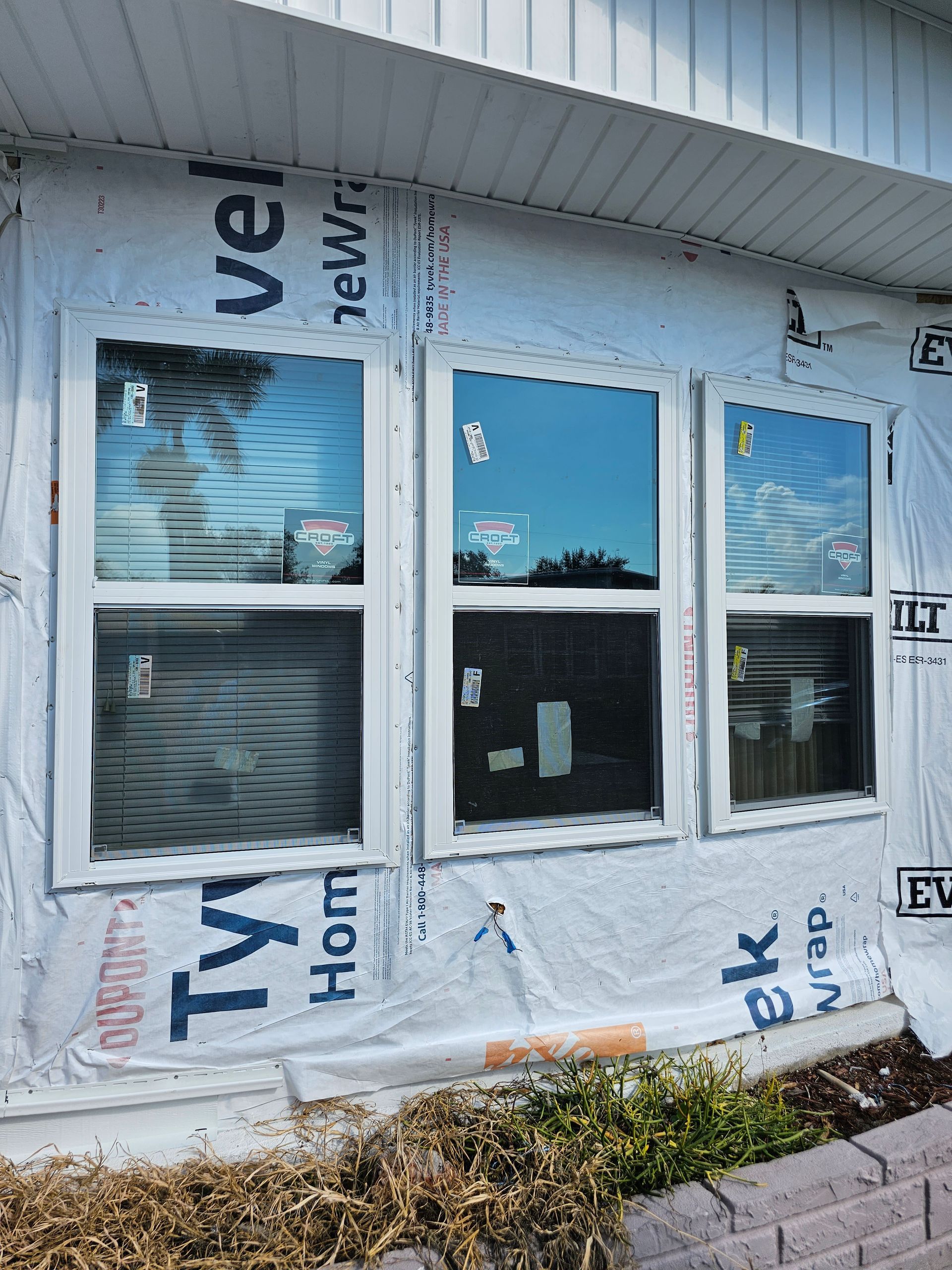 A house with a lot of windows is being remodeled.