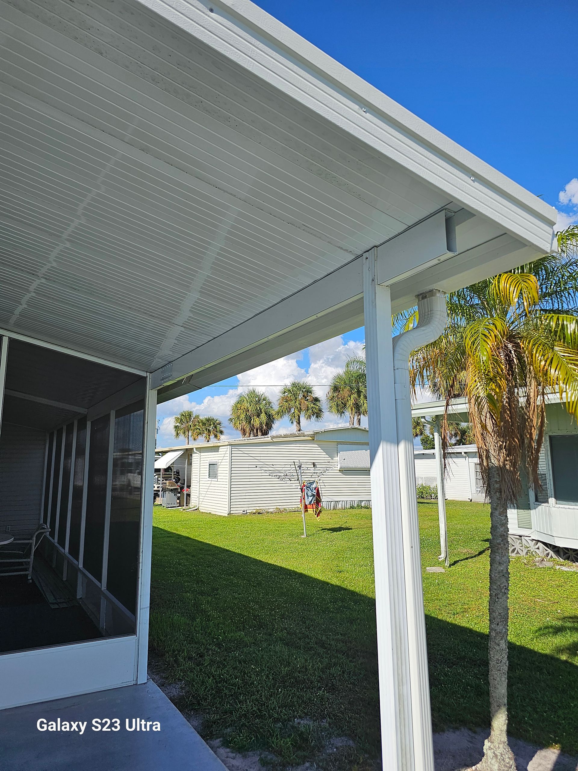 A galaxy s20 ultra is being used to take a picture of a covered porch.