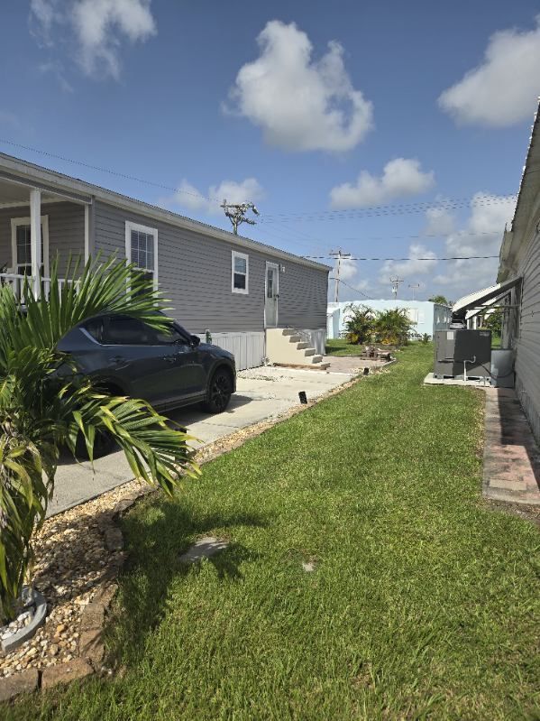 A mobile home with a car parked in front of it.