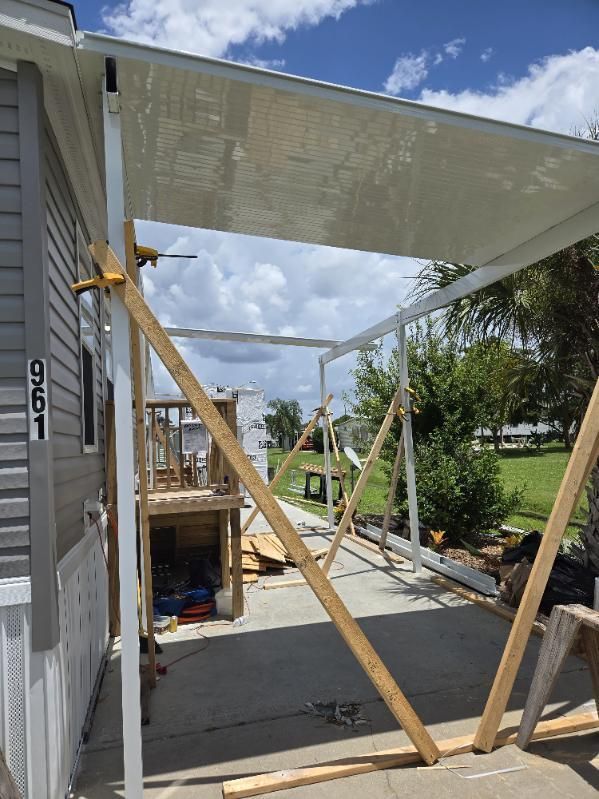 A mobile home is being remodeled and a covered porch is being built.