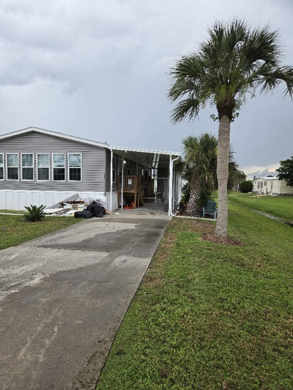 A mobile home with a palm tree in front of it.