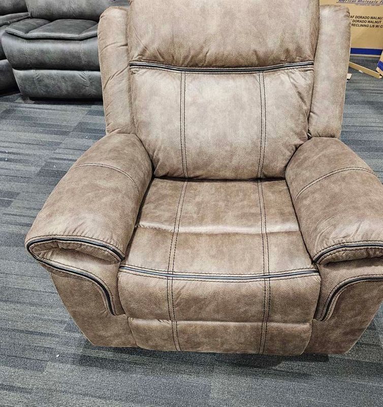 Brown leather recliner chair with stitched detailing.