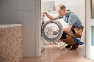 Repair Man Checking the Washing Machine — Elyria, OH — Expert Appliance Solutions