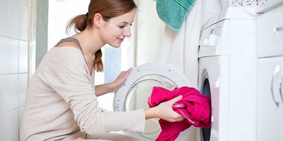 Woman Putting Clothes in Washing Machine — Elyria, OH — Expert Appliance Solutions