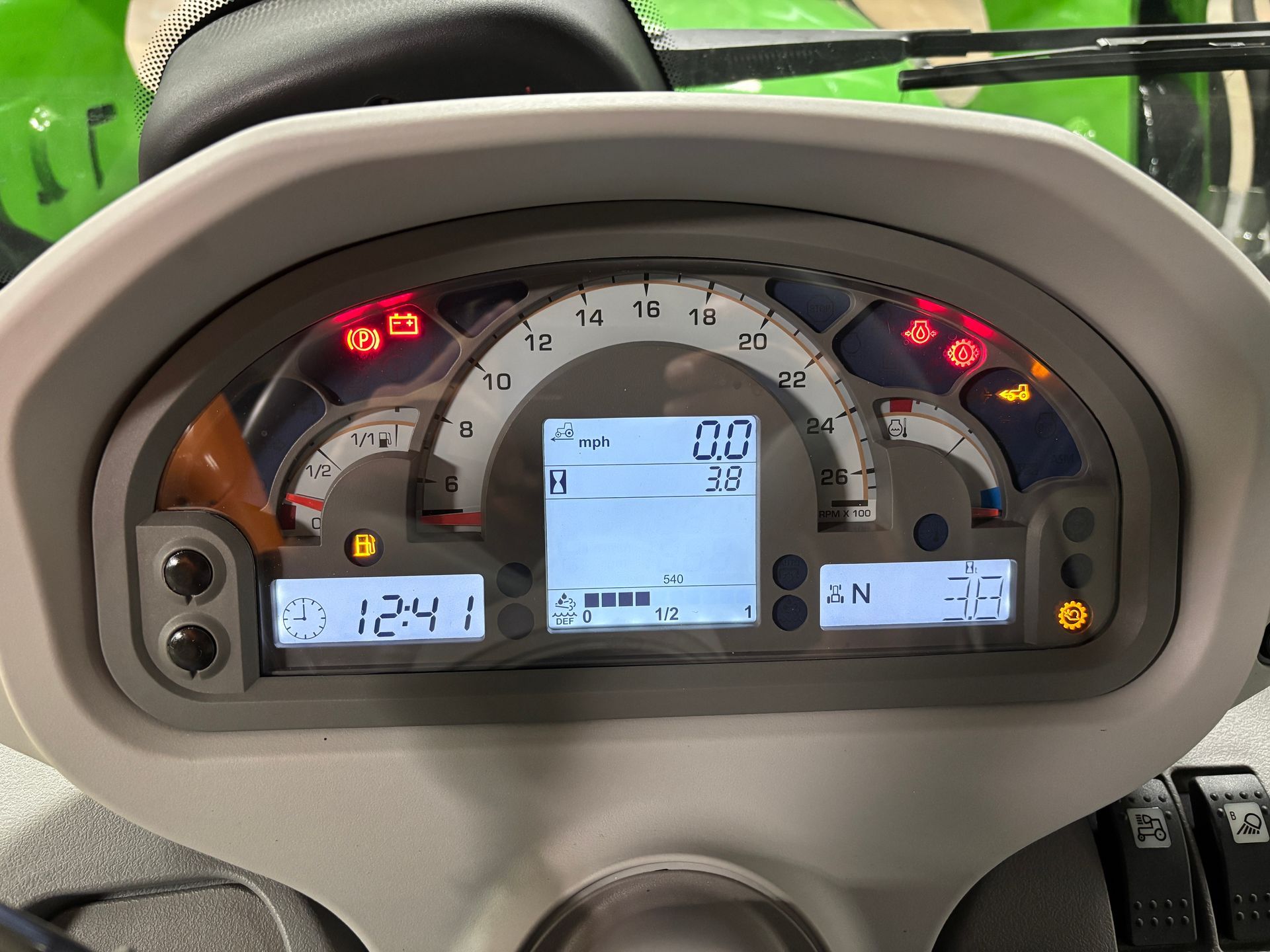 Dashboard with gauges and illuminated warning lights, reading 0.0 mph.