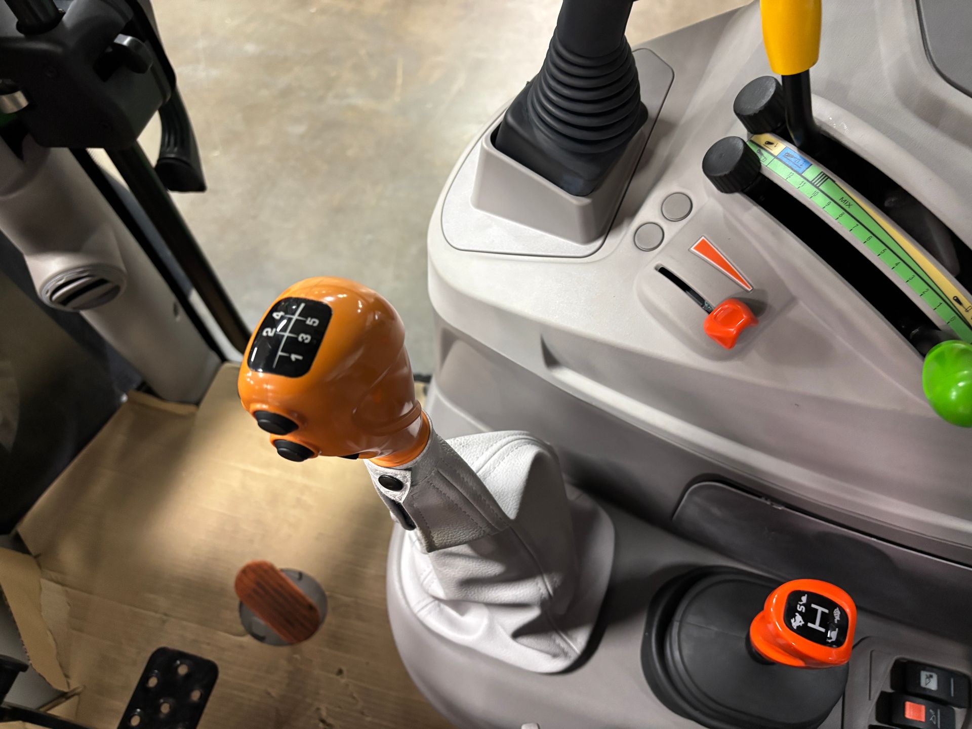 Orange tractor gear shift and controls.
