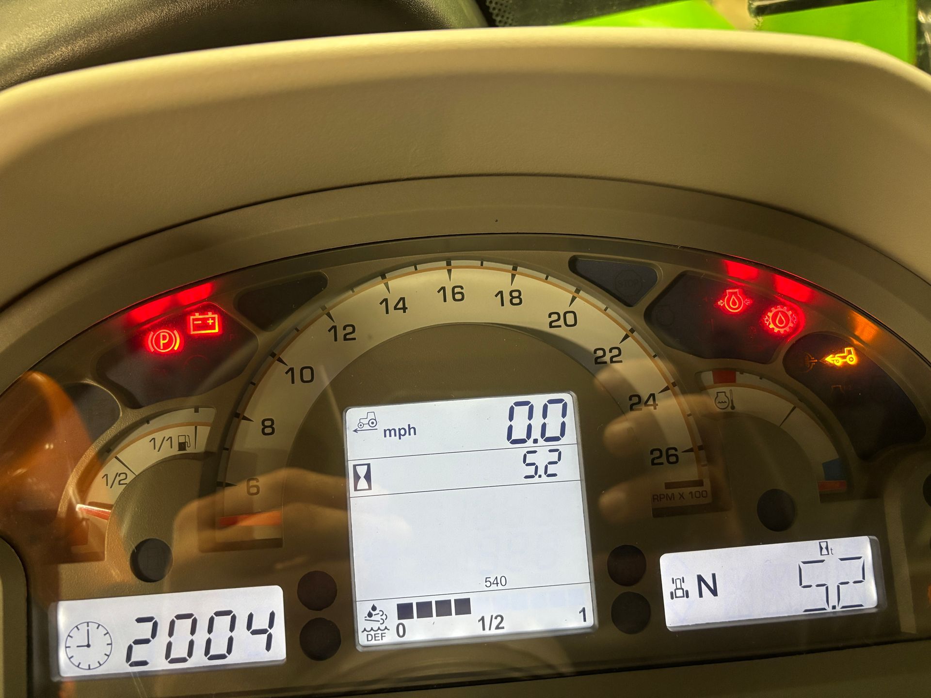 Dashboard with illuminated warning lights, digital speed display showing 0.0 mph, and other gauges.