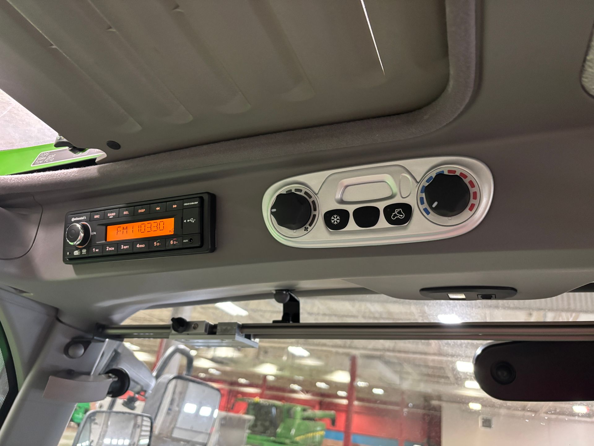 Interior view: Radio and climate controls in a vehicle cabin.