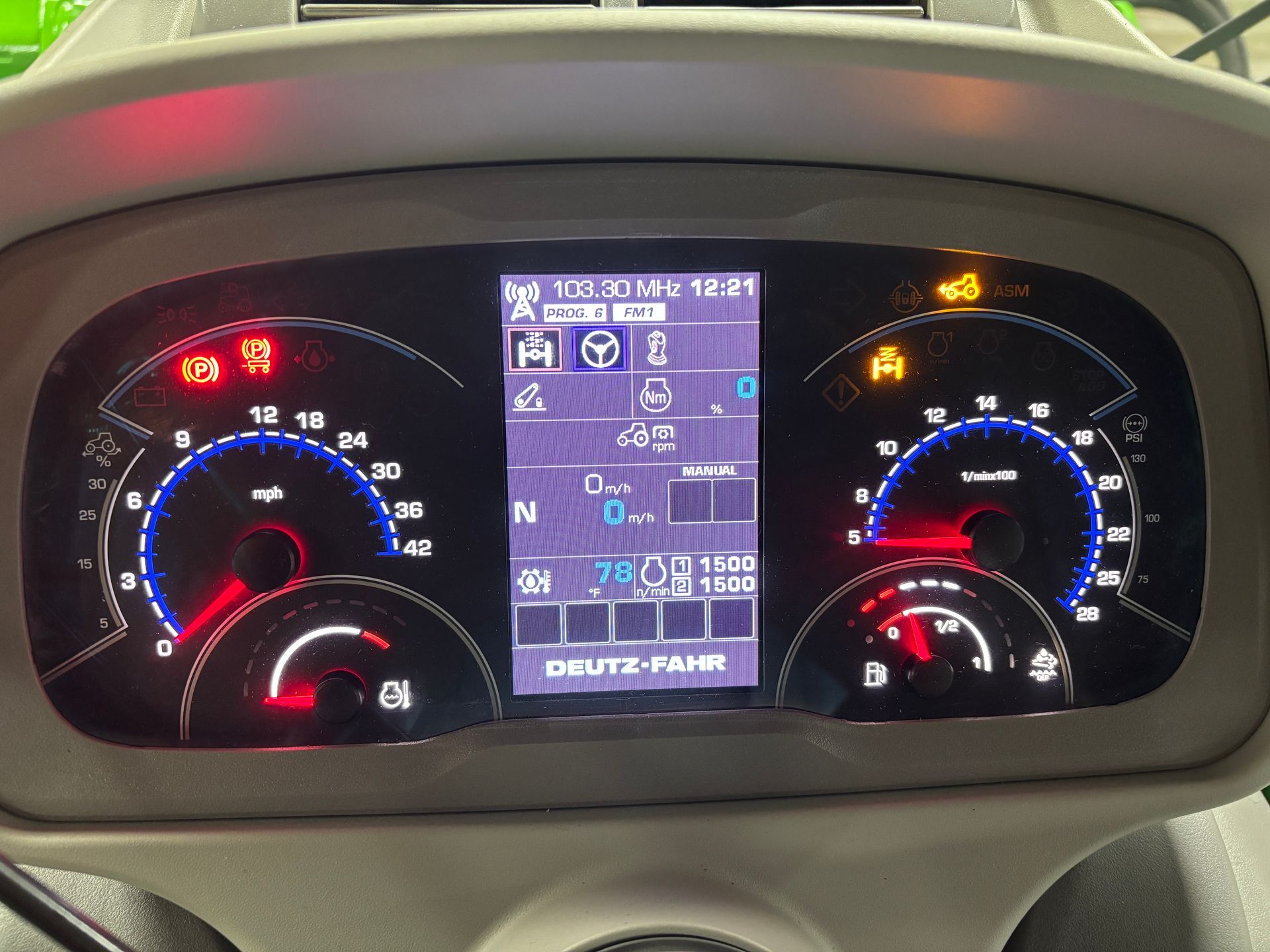 Dashboard of a Deutz-Fahr tractor showing speedometers, gauges, and warning lights. Digital display provides additional information.