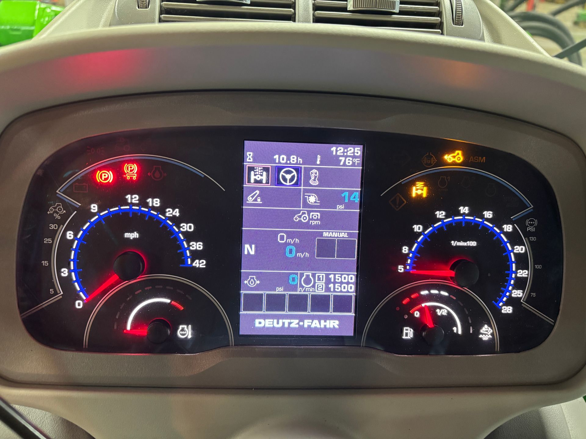 Dashboard of a Deutz-Fahr tractor with gauges, warning lights, and digital display showing operating information.