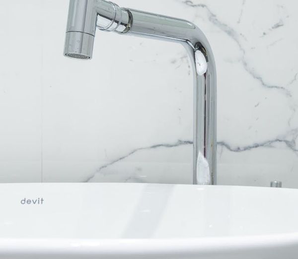 A close up of a bathroom sink with a chrome faucet