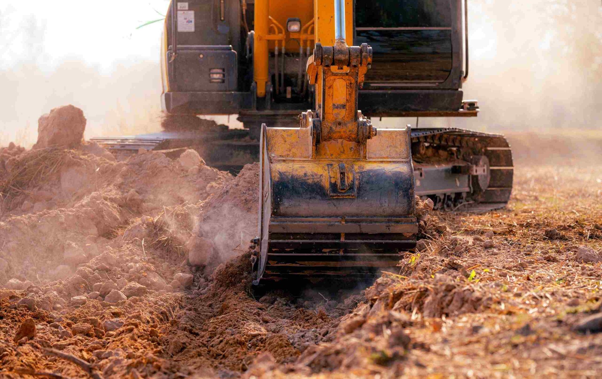 A Bulldozer is Digging a Hole in a Dirt Field — Koumala Quarry In Moranbah, QLD
