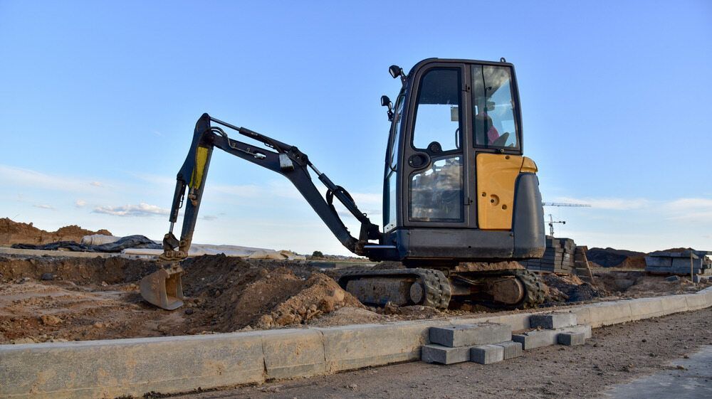 A Small Excavator is Working on a Construction Site — Koumala Quarry In Nebo, QLD