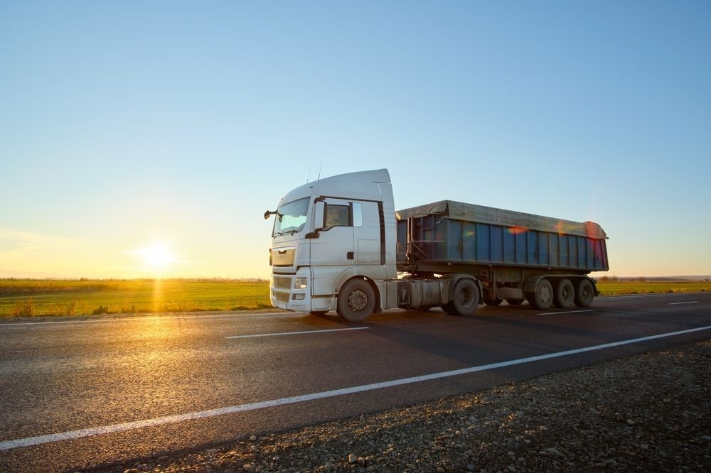 A White Semi-truck With a Blue Cargo Trailer — Koumala Quarry In Koumala, QLD