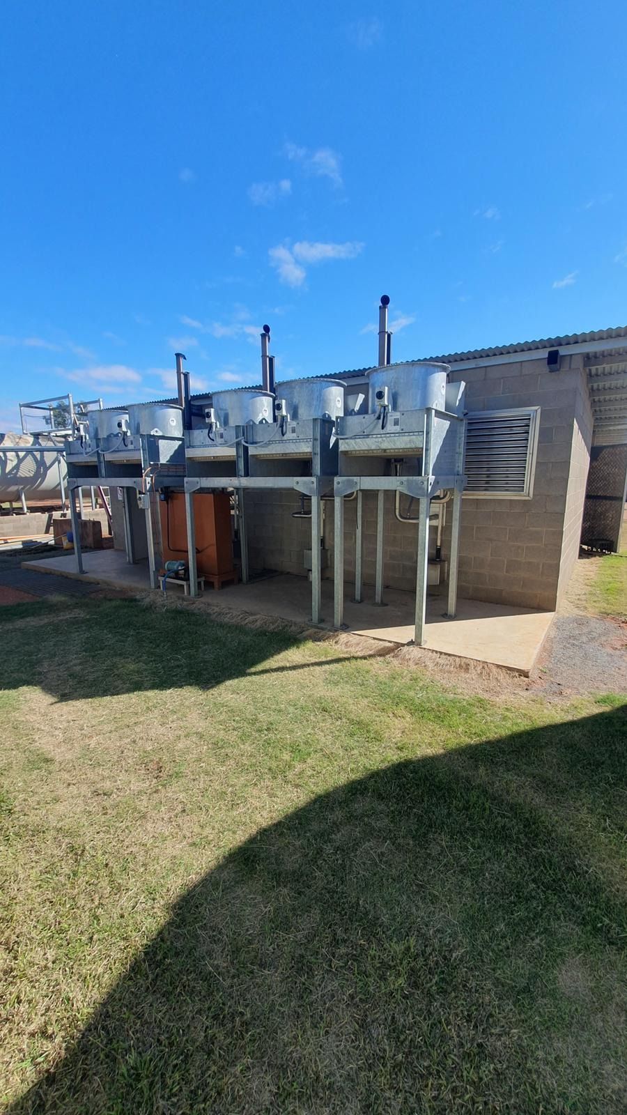 Red and Black Portable Generator on Grass — KAC Generation & Mechanical Pty Ltd In Bungalow, QLD