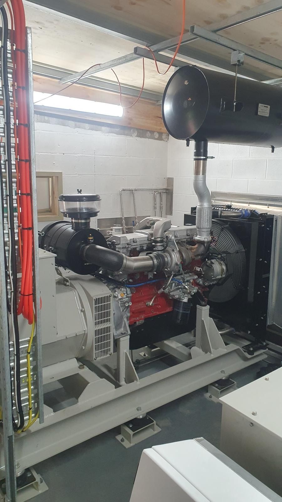 Generator on Grass, Enclosed in a Black Metal Frame — KAC Generation & Mechanical Pty Ltd In Bungalow, QLD