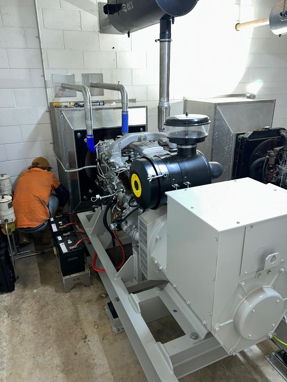 Person in Orange Workwear, Wearing Gloves, Working on Wires — KAC Generation & Mechanical Pty Ltd In Bungalow, QLD