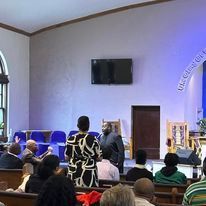 a group of people are sitting in a church .