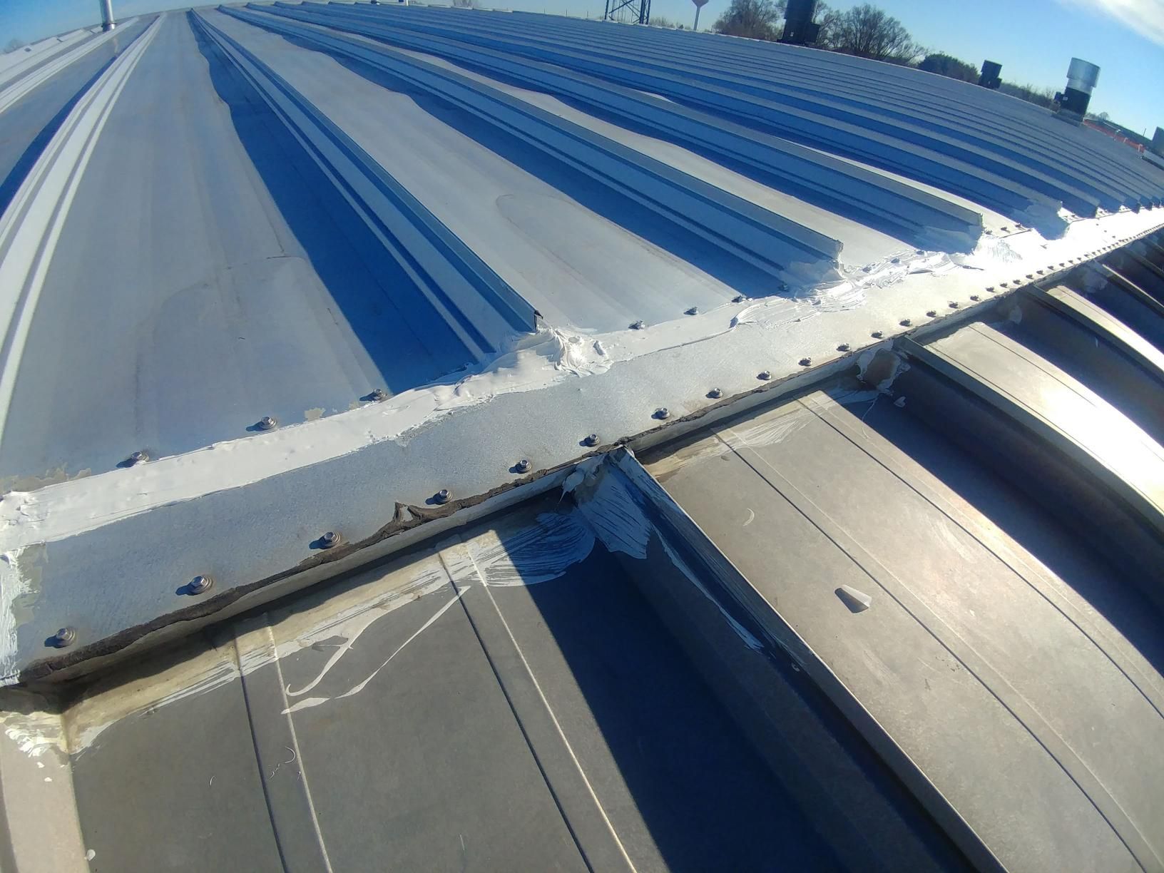 A close up of a roof with a blue sky in the background