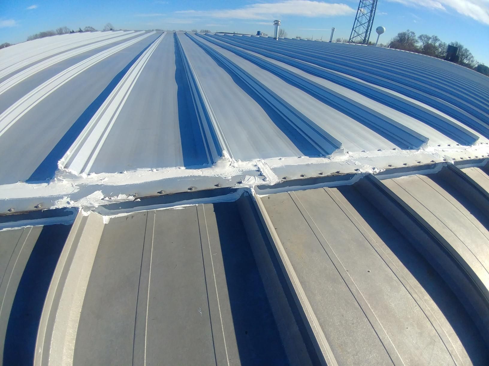 The roof of a building with a blue sky in the background