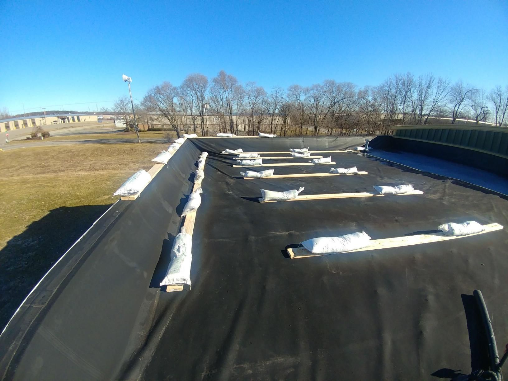 A black roof with a lot of snow on it