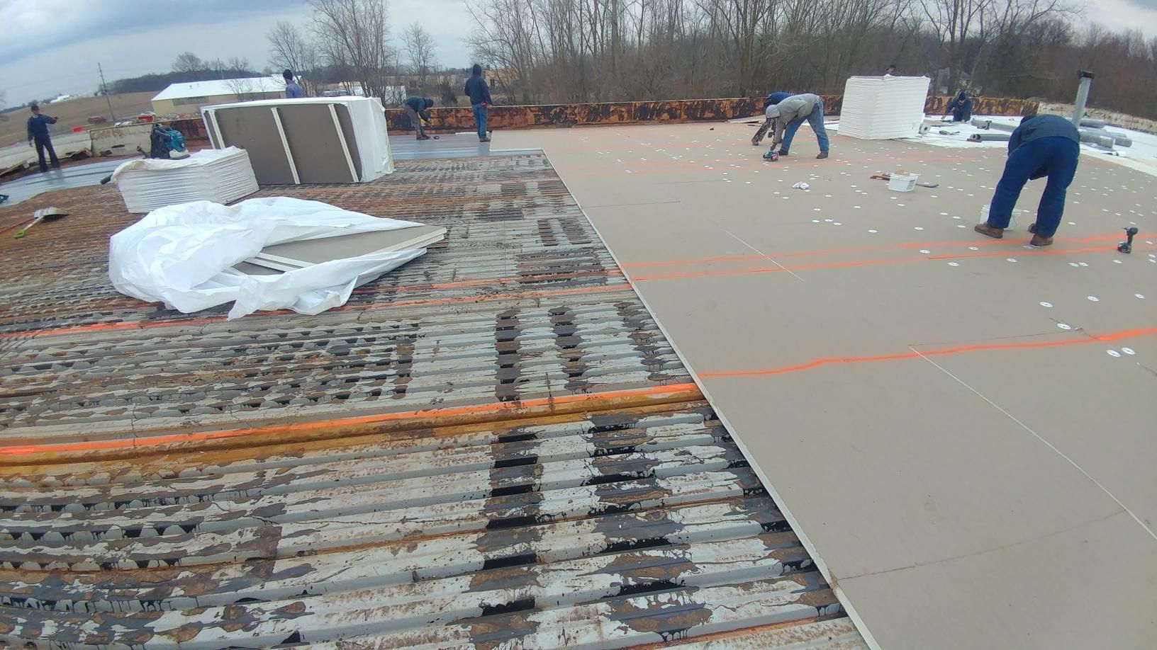 A group of people are working on a roof.