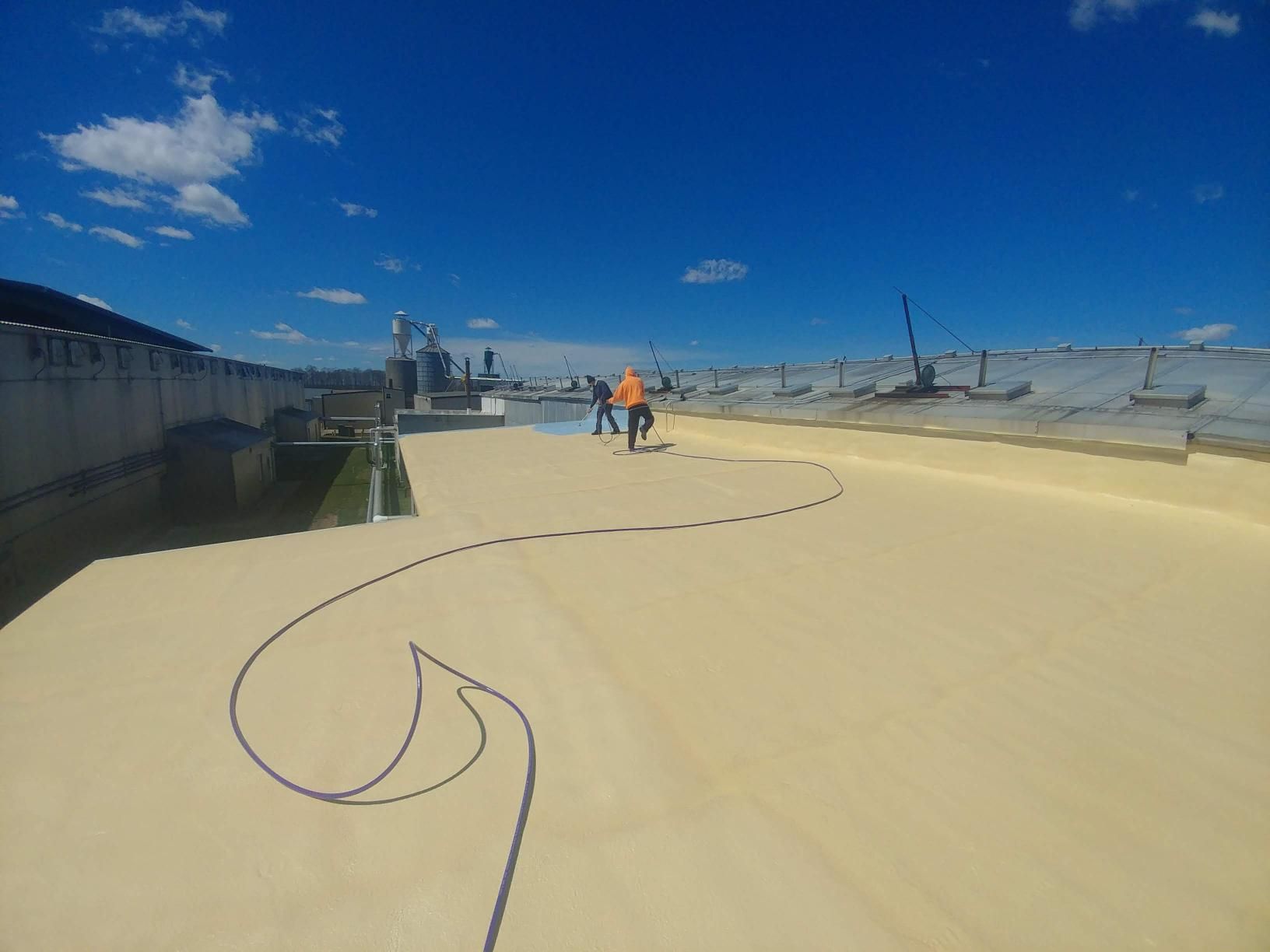 A couple of people standing on top of a sandy surface.