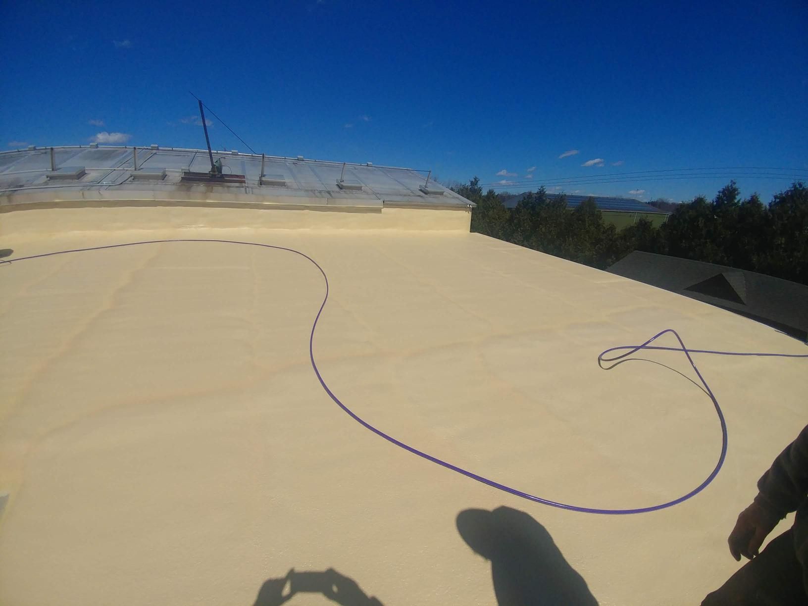 A person is standing on a roof with a drawing on it