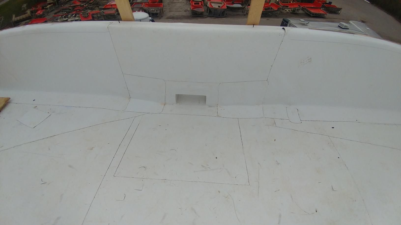 A large white swimming pool is being built in a backyard.