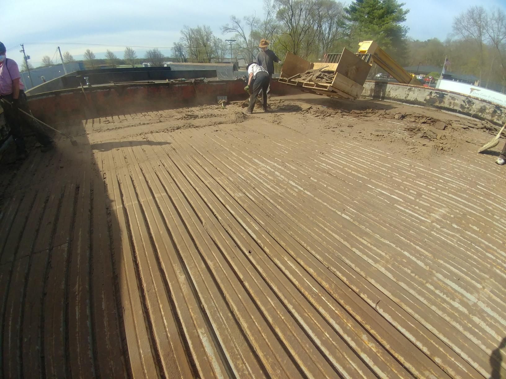 A group of people are working on a wooden deck